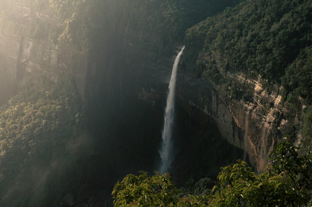 Beautiful view of Nohkalikai Falls cascading down lush cliffs in Meghalaya, India.