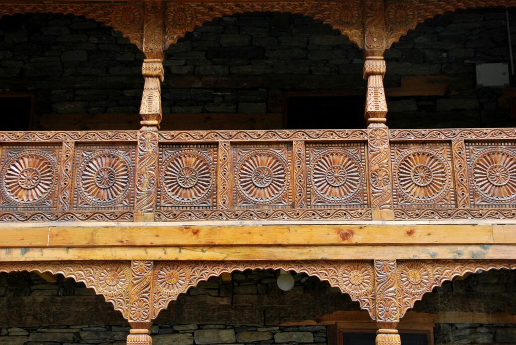 Explore the intricate wooden carvings of the historic Naggar Castle in Himachal Pradesh, India.