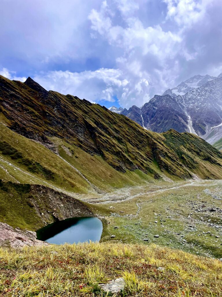 A stunning panoramic view of Beas Kund lake in the Himalayas, Himachal Pradesh, India.