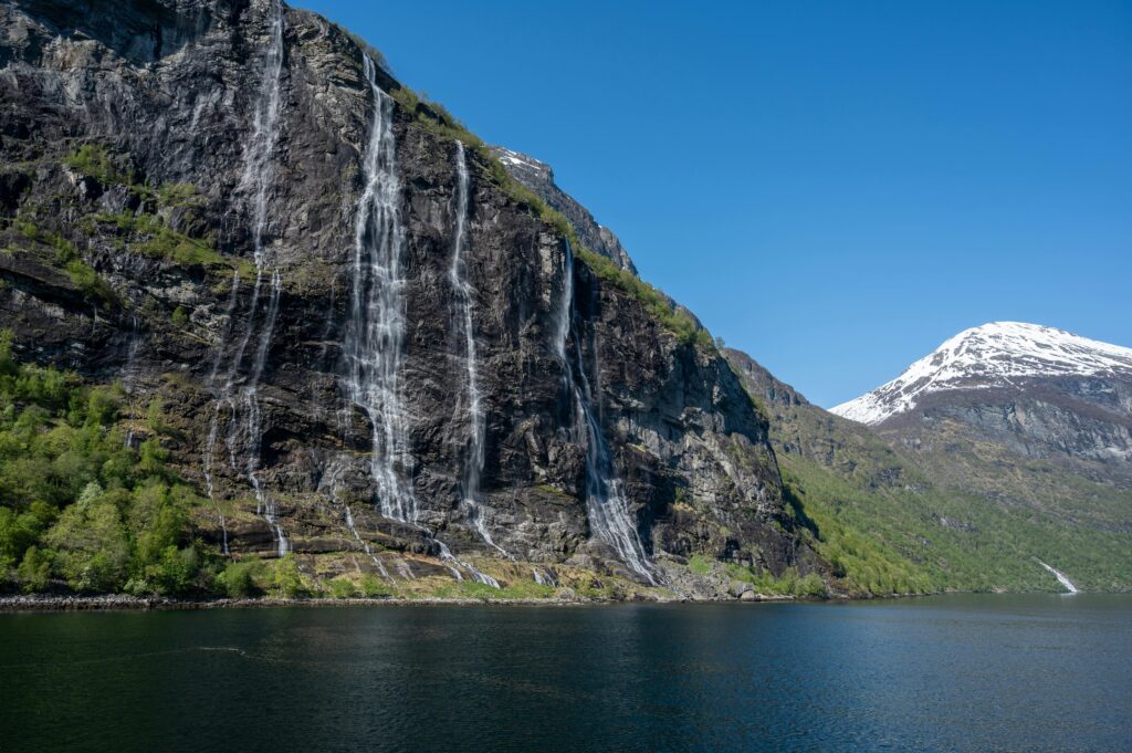 Stunning view of Seven Sisters Waterfall cascading into the Geiranger Fjord in Norway.