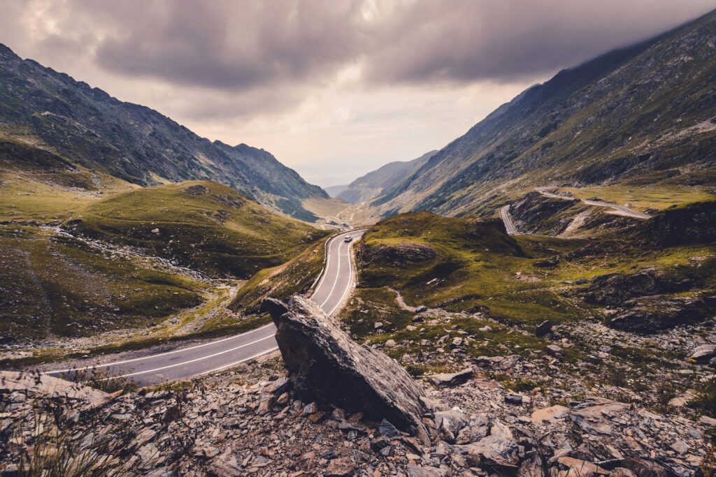 Scenic view of a winding road in the Fagaras Mountains, Romania.