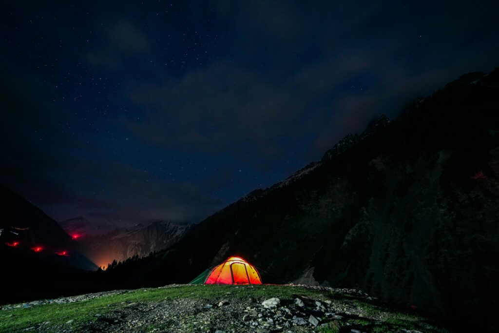 Experience serene camping under a starry sky in Sonamarg's scenic mountain landscape.