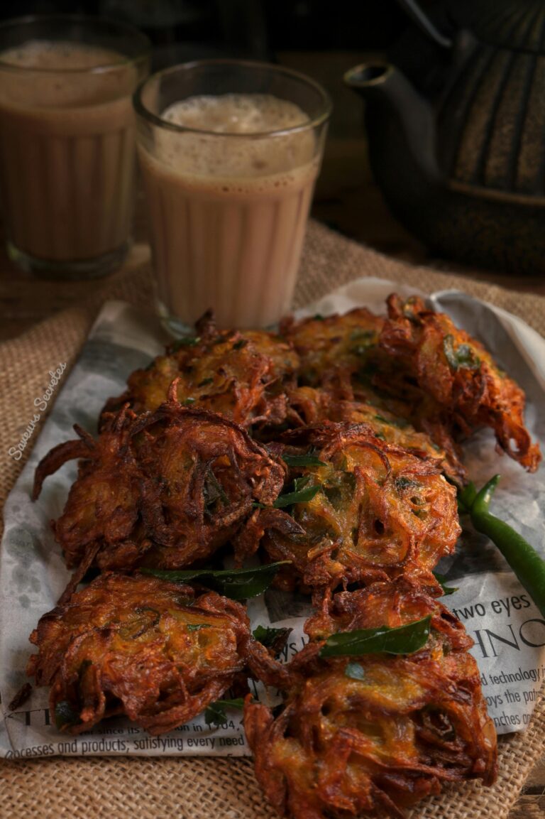 Delicious crispy pakoras served with traditional Indian chai, perfect for a tasty snack.