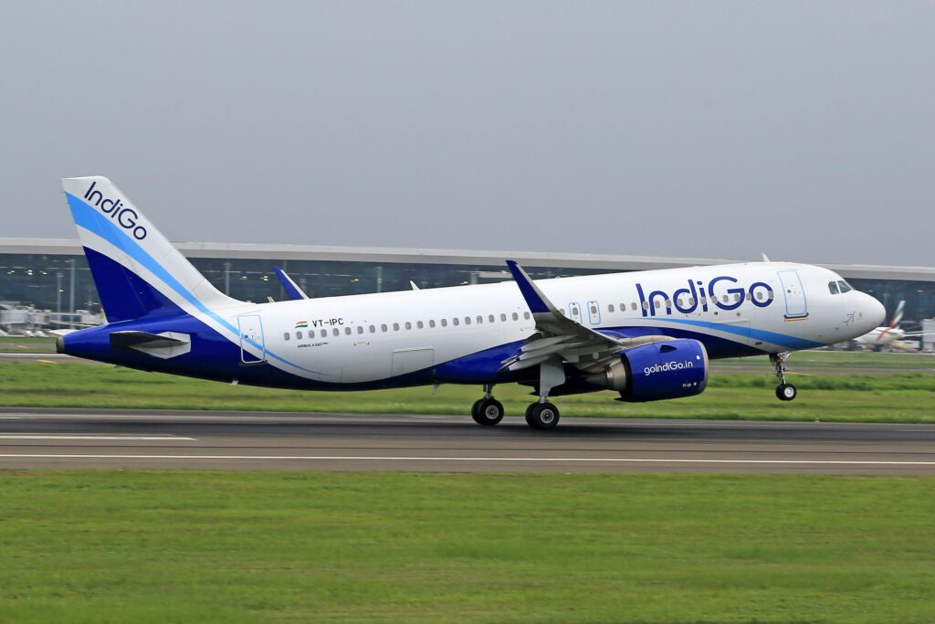 IndiGo Airbus A320 taking off from an airport runway, showcasing modern aviation.