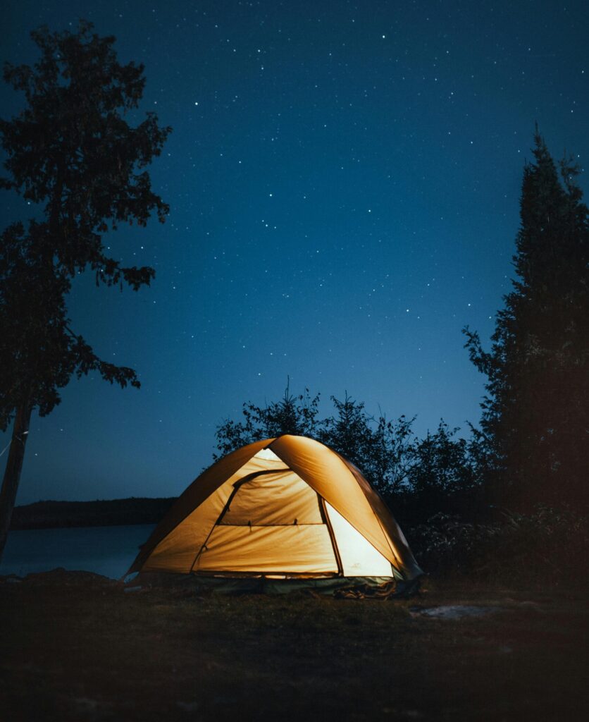 A serene campsite under a starry sky in Ely, Minnesota. Perfect outdoor adventure setting.